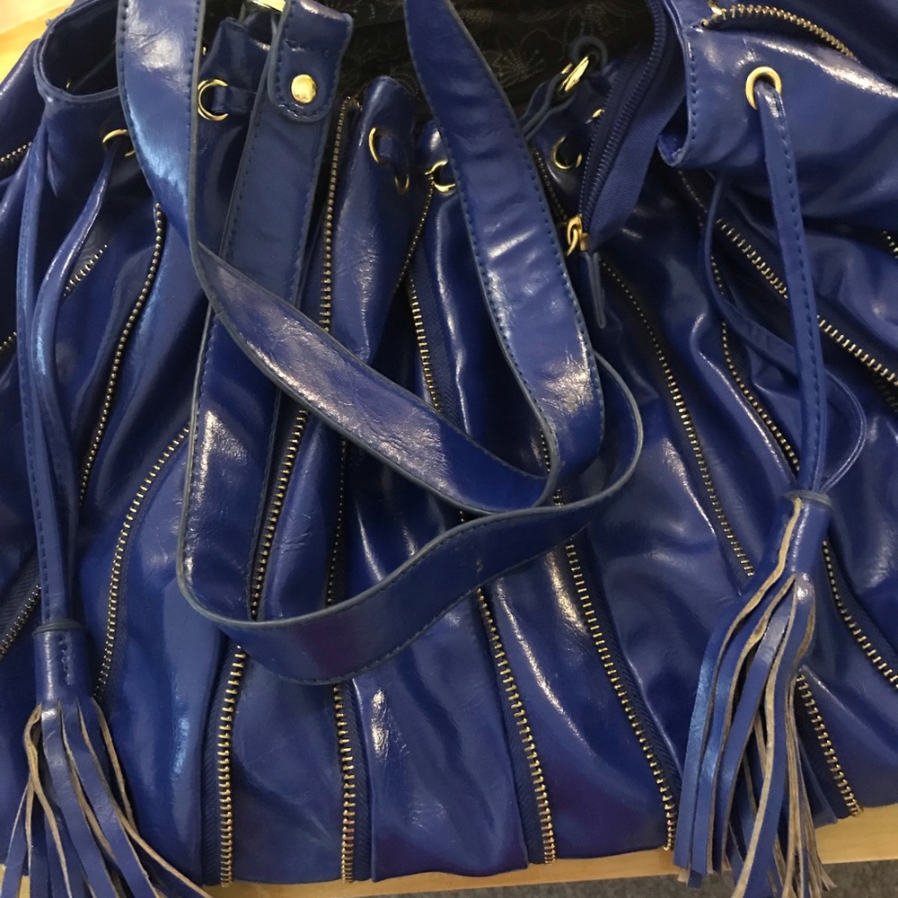 Rich blue soft vinyl oversized shoulder bag with drawstring and zippered accents